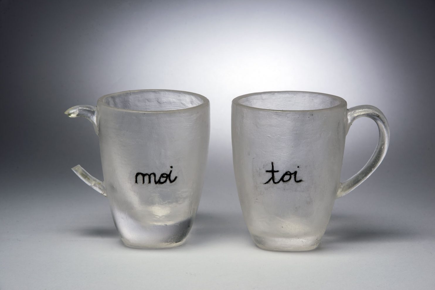 “Moi & Toi” di Silvia Levenson è una scultura in vetro che rappresenta il dialogo tra “io” e “tu” attraverso due tazze trasparenti incise con le parole moi e toi. Un’opera che riflette sulla fragilità e sull’intimità delle relazioni. Esposta alla